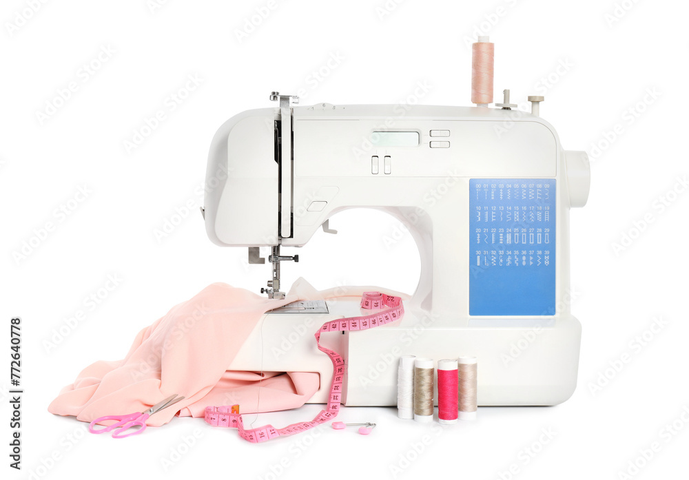 Modern sewing machine with pink cloth and craft accessories isolated on white