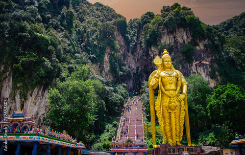 Golden Lord Murugan Statue and Colorful Steps at Batu Caves, Kuala Lumpur, Malaysia photo