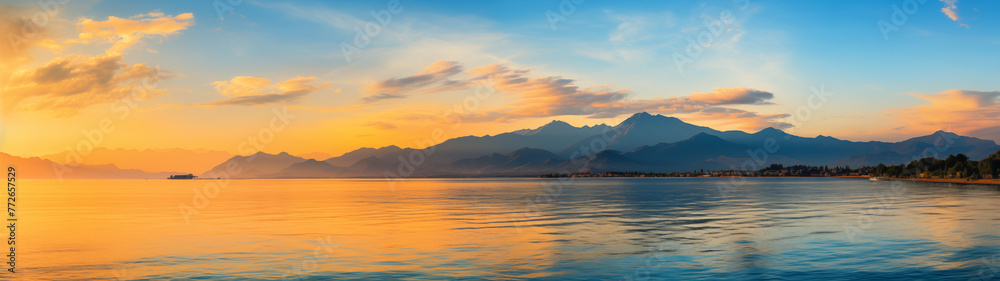Golden Sunrise Over Mountains Reflected in Calm Sea Waters