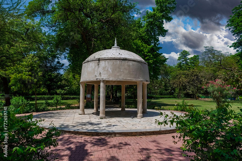 Classical Pavilion with Domed Roof in Serene Park, Lush Landscaping, Mature Trees, Partly Cloudy Sky