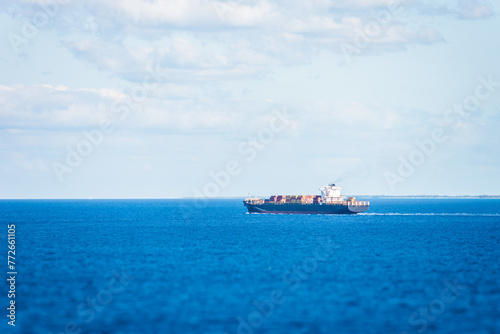 Fototapeta Naklejka Na Ścianę i Meble -  Cargo container ship sailing through calm Atlantic Ocean.