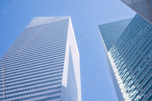 Gaze upwards at the sleek geometry of New York s skyscrapers  where the contrast of glass against the blue sky epitomizes urban aspiration