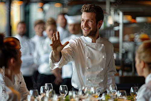 The chef gives instructions to the restaurant staff.