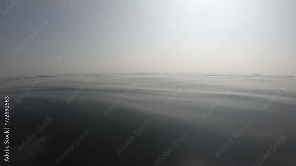 water wave surface of outdoor swimming pool in summertime, motion scene with cloud in the sky