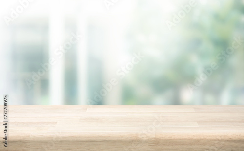 Selective focus.Wood table counter on blur green garden garden from window view background.