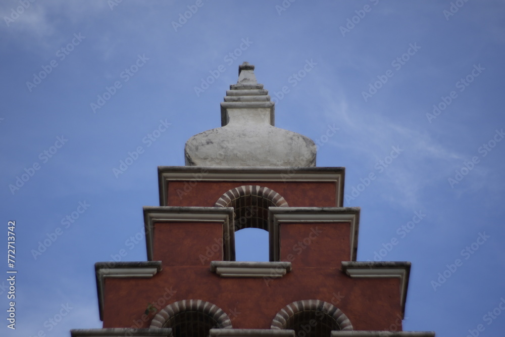 wall with window circle brick church Spanish style and bell tower