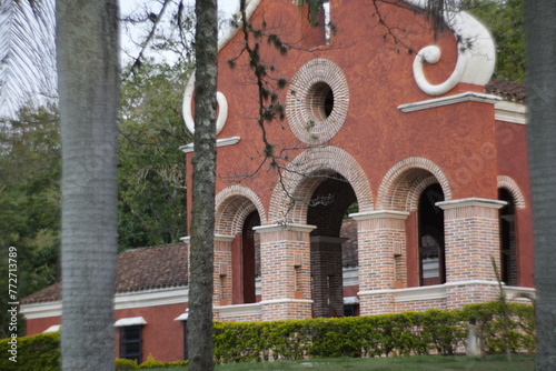wall with window circle brick church Spanish style and bell tower