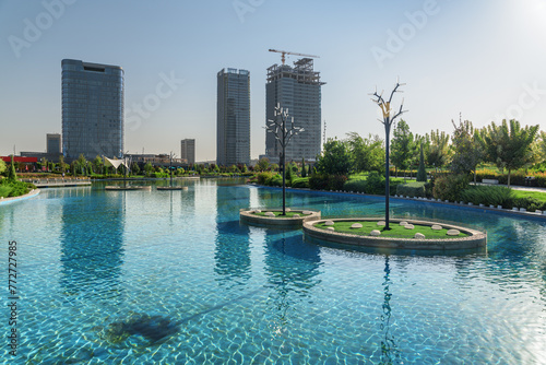 Contemporary buildings reflected in pool of Tashkent City Park © efired