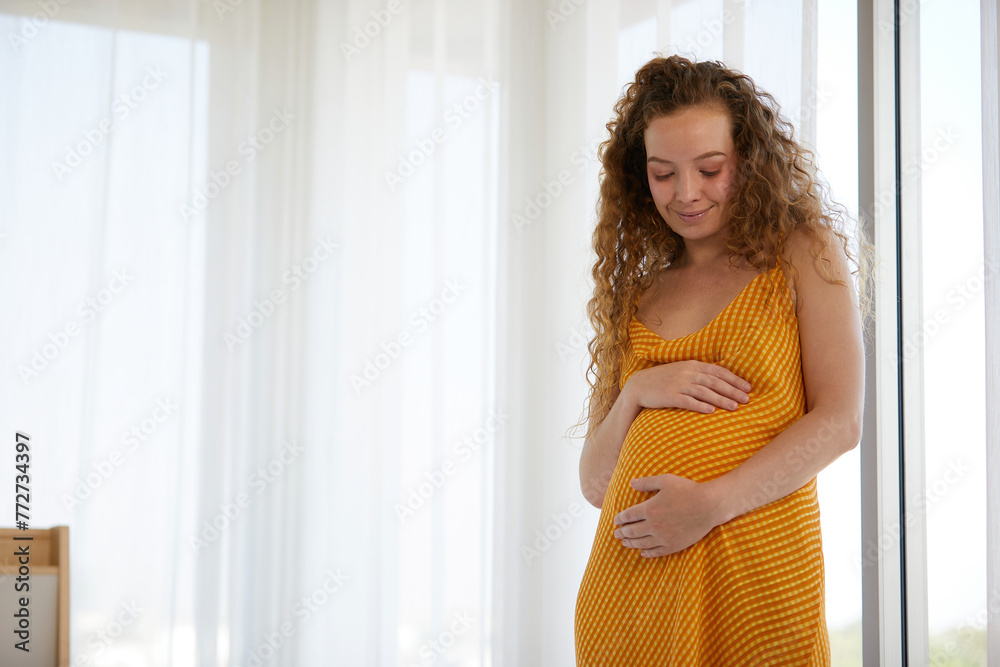 pregnant woman smiling and relaxing in the bedroom pregnant woman smiling and relaxing in the bedroom