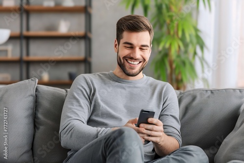 Caucasian man playing with smartphone while laughing