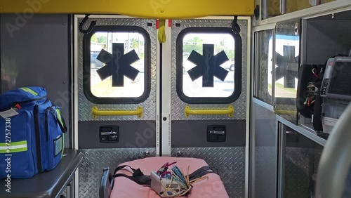View from inside ambulance patient compartment driving down the road. 