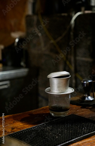 Dripping coffee being made at the counter with aluminum filter