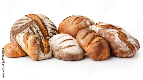 An assortment of freshly baked bread loaves with various crusts and patterns, arranged on a white surface.