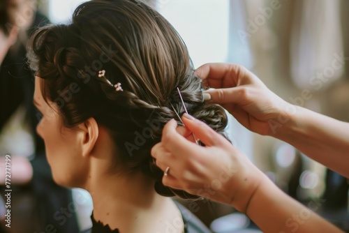 stylist pinning up brides hairdo