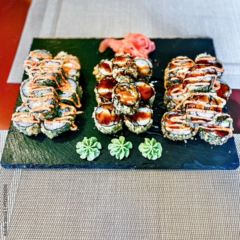 Sushi set on a black plate, close-up, selective focus