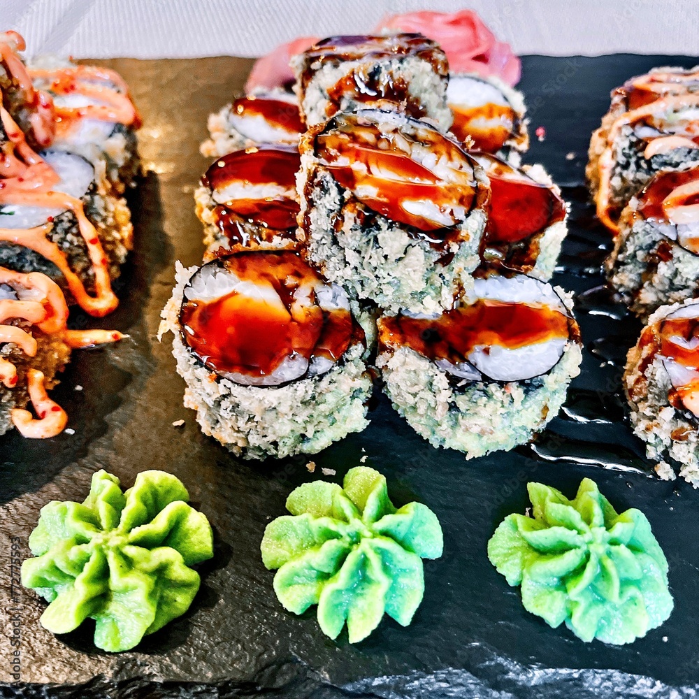 Sushi set on a black plate, close-up, selective focus
