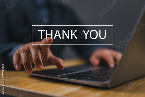 businessman using a laptop sends the message thank you on a display screen. concept of thank you business, appreciation and gratitude, congratulations, presentation from technology digital