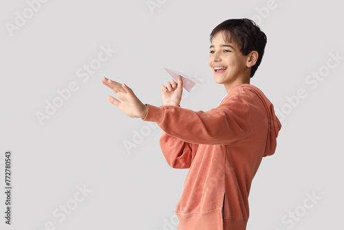 Little boy with paper plane...