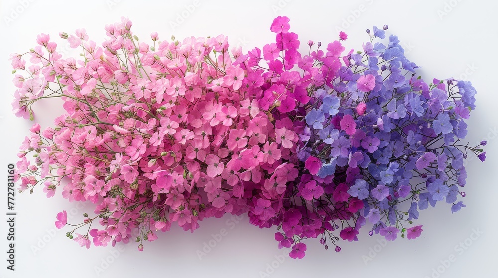   A cluster of lilac and rose blossoms resting atop a white table