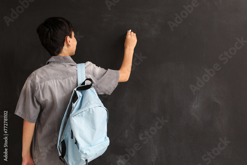 Little boy with chalk piece...