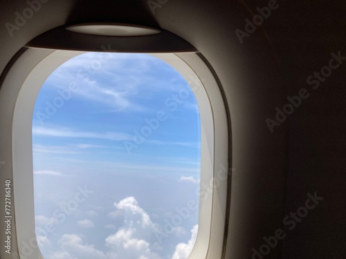view from an airplane’s shade when up in the sky, seeing the cloudscape view and the bright blue sky
