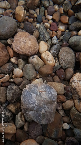 abstract Textured background with round pebble stones. Vacation holiday recreation on beach concept. High quality photo. Fragment with a texture of rock. surface  stone wall with cracks.