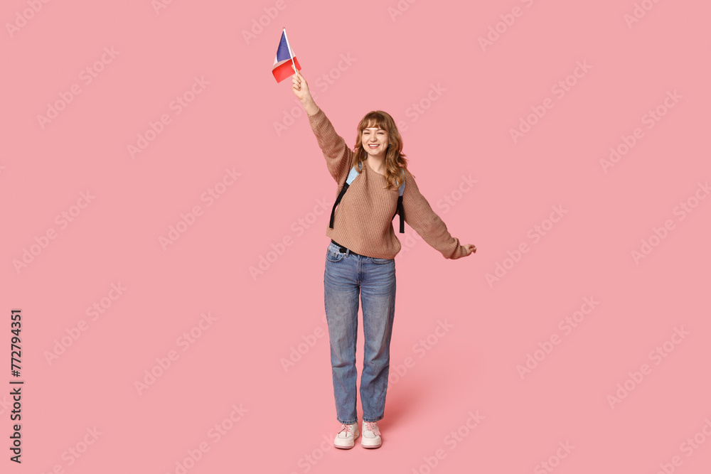 Female student with French flag on pink background Female student with French flag on pink background