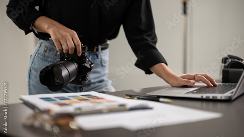 Bild auf Leinwand A cropped shot of a female photographer checking images on a laptop computer in a studio