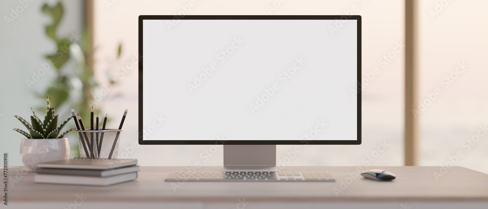 A front view image of a PC computer white-screen mockup on a desk in a modern bright office. - obrazy, fototapety, plakaty 