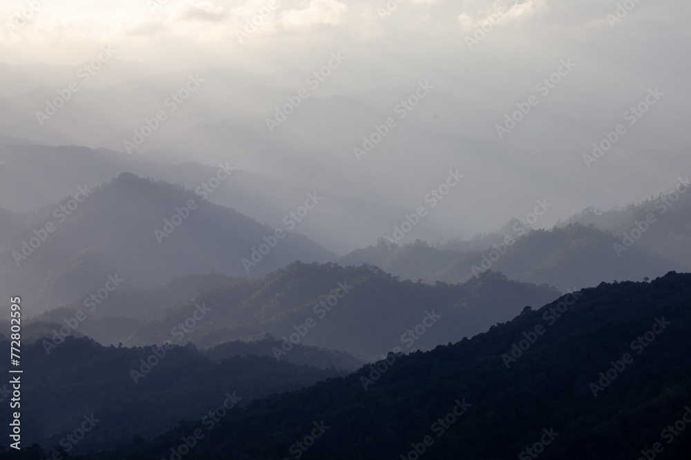 Complex mountain landscape The light peeking out from the clouds looked amazing and beautiful. Background image of mountains and clouds Complex mountain landscape The light peeking out from the clouds looked amazing and beautiful. Background image of mountains and clouds
