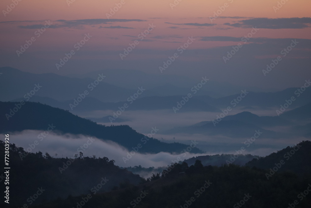 Background image of a morning landscape on a mountaintop with mountains and a sea of mist before the sun rises. There is space for text. Background image of a morning landscape on a mountaintop with mountains and a sea of mist before the sun rises. There is space for text.
