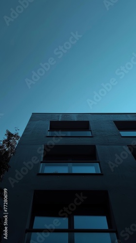 Low angle view of modern building facade at twilight