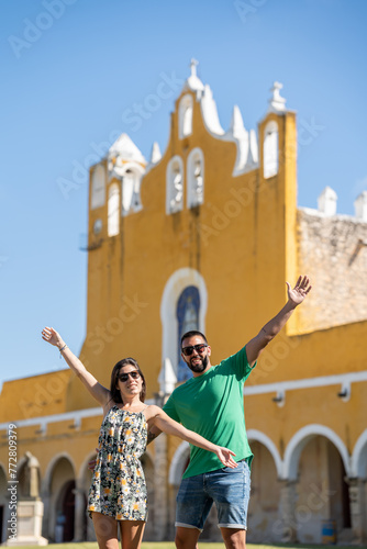 Young tourist couple with sunglasses at the Izamal convent enjoying the visit in Mexico.