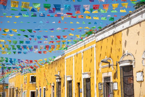 Colorful street decorated with little flags in the city of Izamal in Mexico