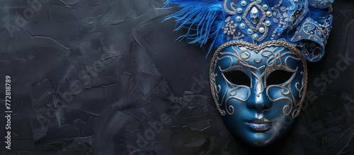 A captivating blue Venetian mask adorned with feathers and jewels  set against a textured dark background