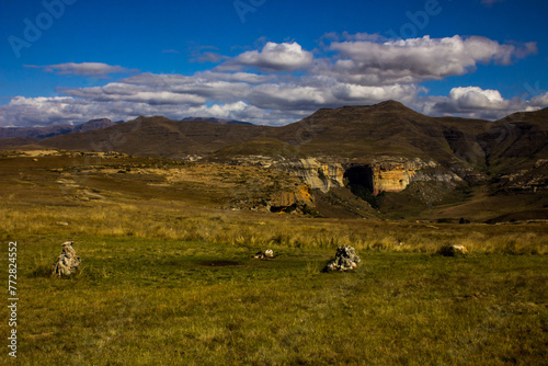 View over the Afroalpine grasslands with the peaks of the Drakensberg Mountains rising in the background, as seen from the vulture restaurant in Golden Gate Highlands National Park, South Africa