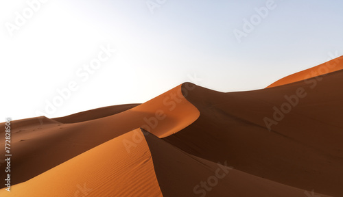view of the sand dunes at Erg Chebbi in Morocco in warm evening light photo