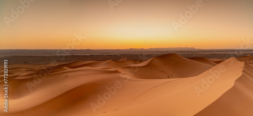 view of the sand dunes at Erg Chebbi in Morocco at sunset photo