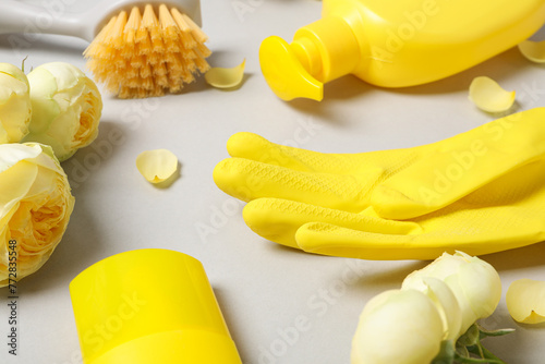 Rubber gloves with flowers, rag and detergents