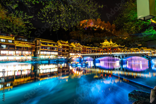 Laser show at Feng Huang Ancient Town (Phoenix Ancient Town) and tourist boats on Tuo Jiang River, The famous tourist destination at Hunan Province, China