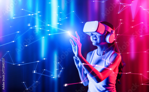 Smart female standing surrounded by neon light wearing VR headset connecting metaverse  future cyberspace community technology. Elegant woman using finger touch virtual reality object. Hallucination.