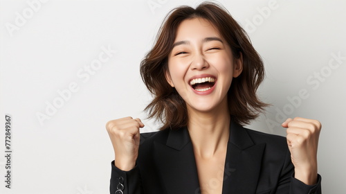Successful Korean businesswoman clenches her fists and cheers with a happy expression. Asian female job applicant rejoicing over passing. Isolated on white background. Copy space. Generative AI