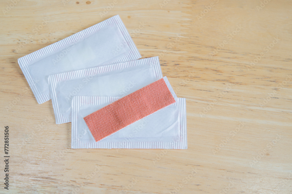 Top view image of medical equipment - adhesive plasters on wooden background. Top view image of medical equipment - adhesive plasters on wooden background.