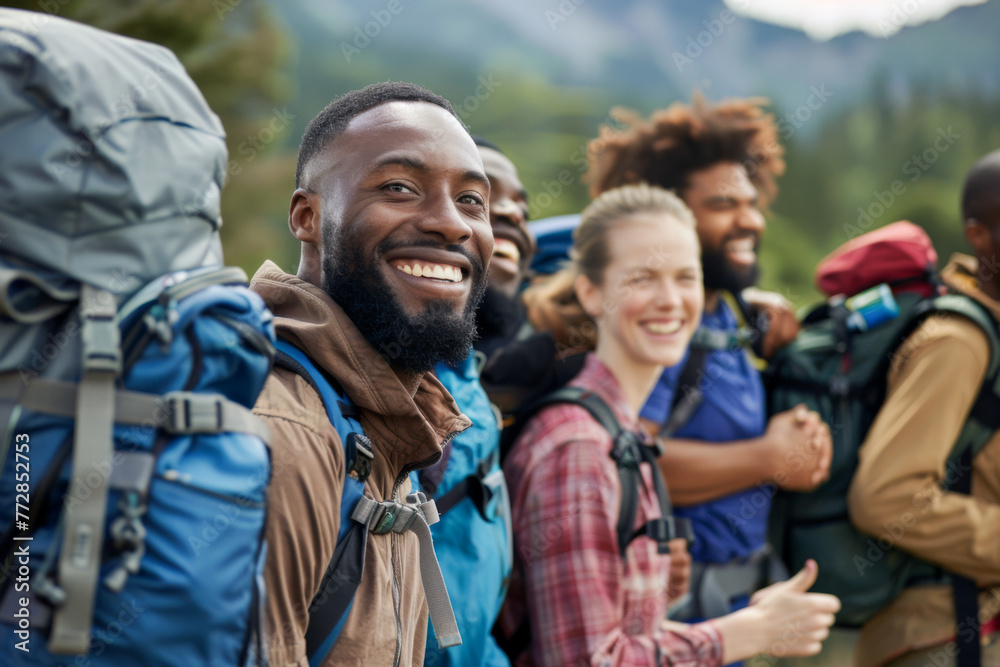 Group of happy friends with backpacks smiling at camera while hiking in mountains
Group of happy friends with backpacks smiling at camera while hiking in mountains