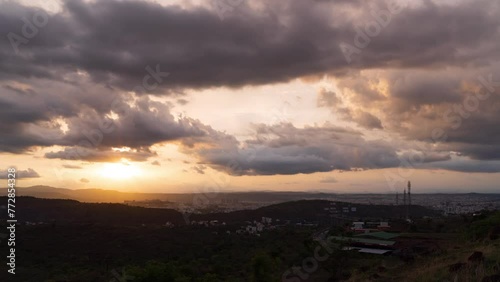 Timelapse of sunset over a city during golden hour with dramatic clouds in the background. Shot in 4K ultra HD smoothest and clearest video.