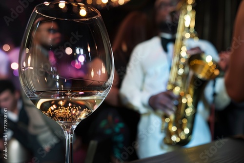 club guests view of saxophonist through a filled wine glass