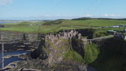 Dunluce Castle is one of the most picturesque and romantic of Irish Castles. With evidence of settlement from the first millennium, date mainly from the 16th and 17th centuries. Aerial Shot. Part 7. photo