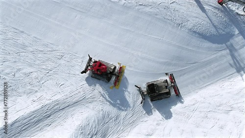 Snow Groomer and Piste Basher Working on a Ski Piste Aerial View photo