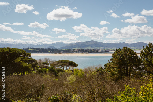 Coastal landscape in northern Spain with mountains in the background.