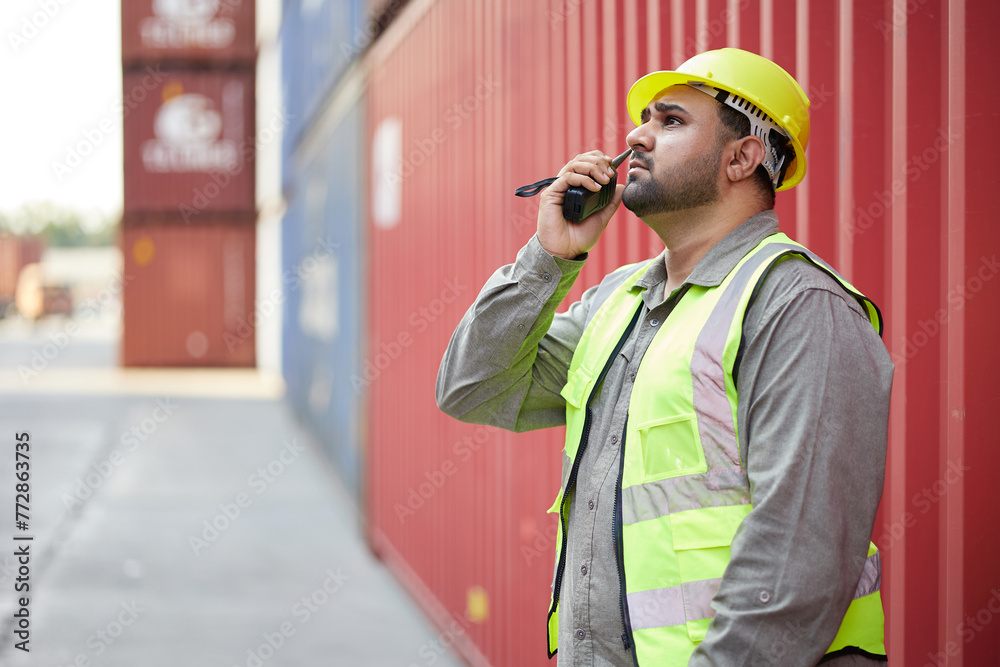 worker or engineer using walkie talkie and talking about work in containers warehouse storage worker or engineer using walkie talkie and talking about work in containers warehouse storage